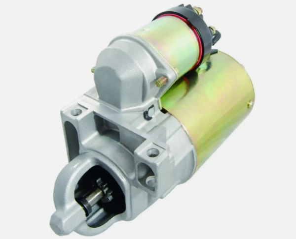 Automotive starter motor with solenoid on top and drive gear at the end against a white background