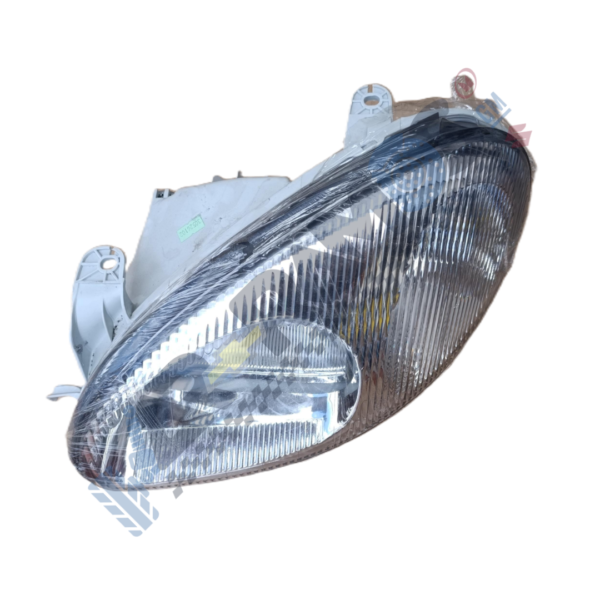 Designer - Autorepuestos Ramos Headlight assembly for a car with reflective housing and clear lens, angled shown to display mounting tabs and inner reflector