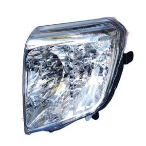 Designer 2 Close-up of a car headlight with a clear lens and multiple reflective segments inside the housing.