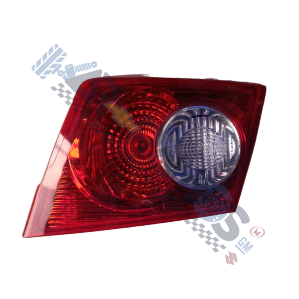 Car rear taillight assembly with red lens and a clear circular reverse light section.