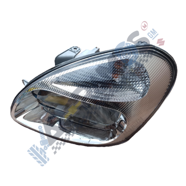 Car headlight assembly with clear lens and reflectors, viewed from an angled side.