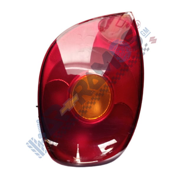 Rear car taillight assembly with red lens and a central amber/orange reflector light.