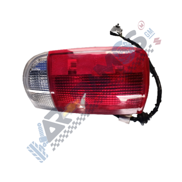 Automotive tail light assembly with red lens and clear indicator section, attached wiring harness